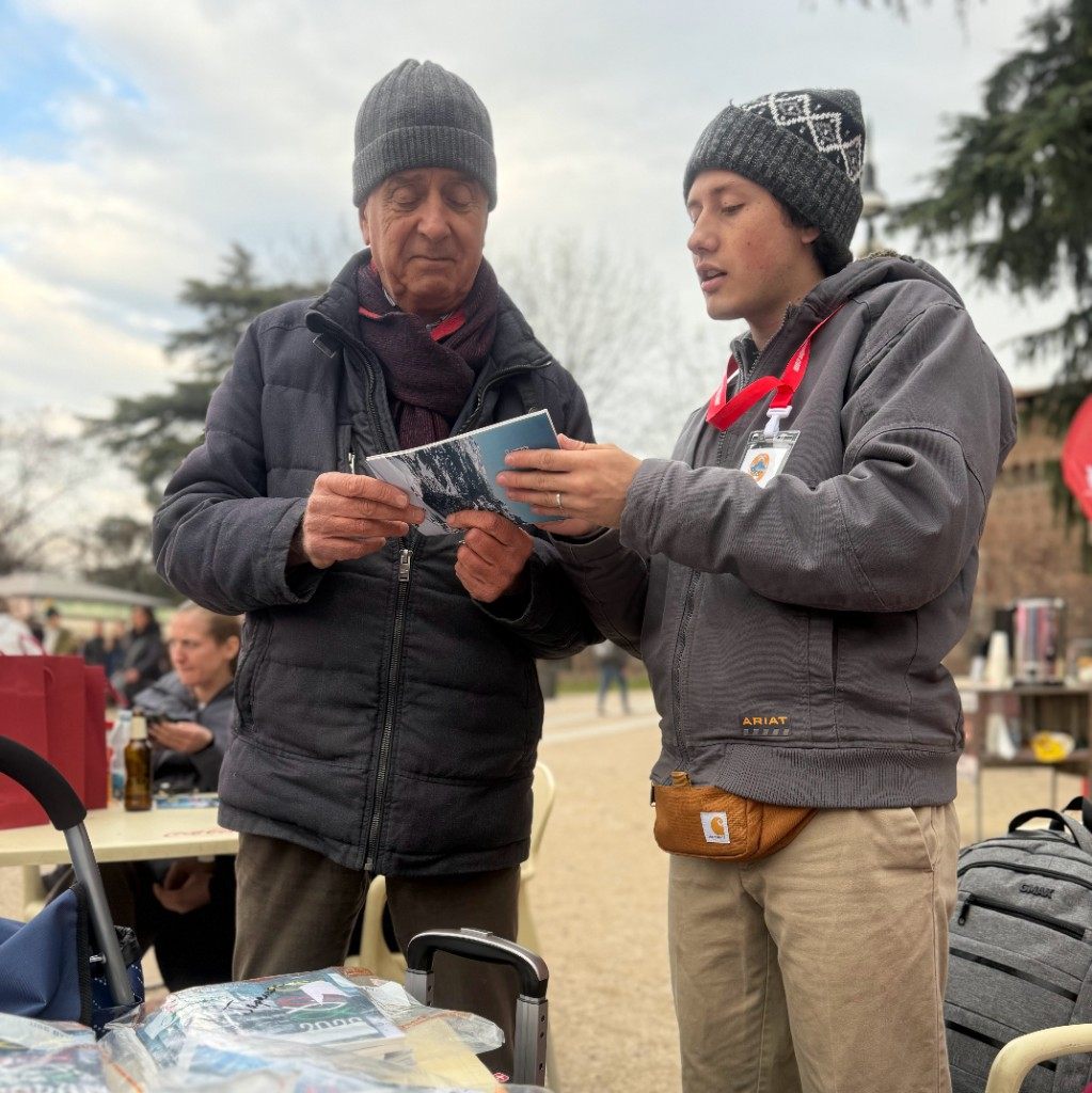 Sharing a Gospel tract one-on-one during outreach
